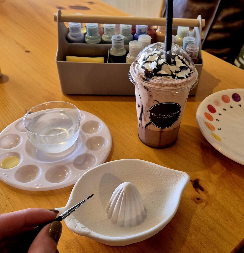 Painting pottery with a frappé from the café