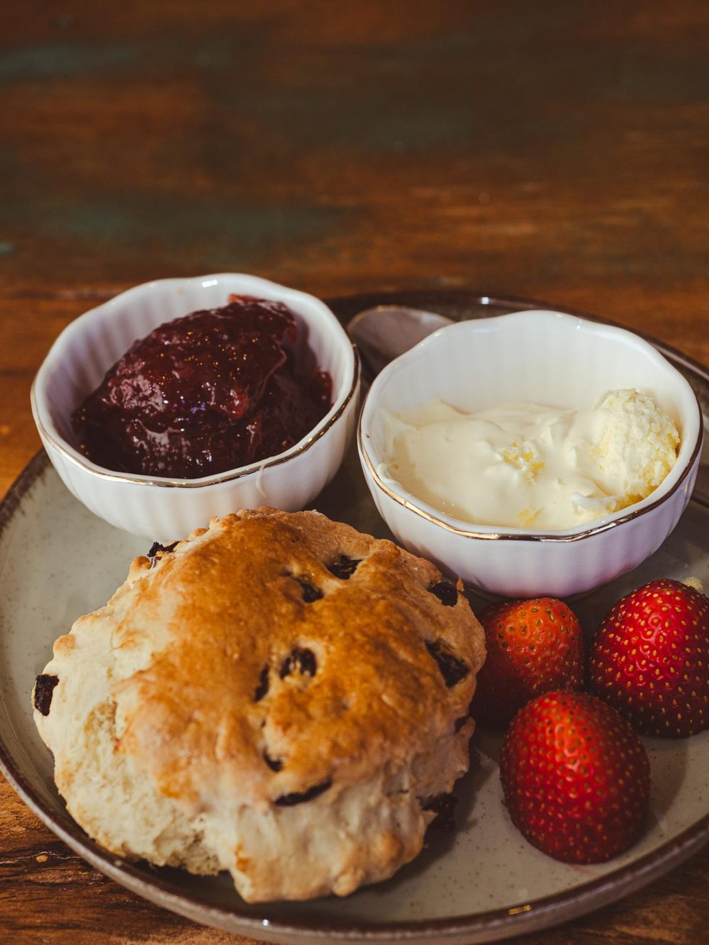 Scone with jam, clotted cream and strawberries